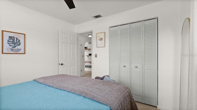 bedroom with a closet, visible vents, and ceiling fan