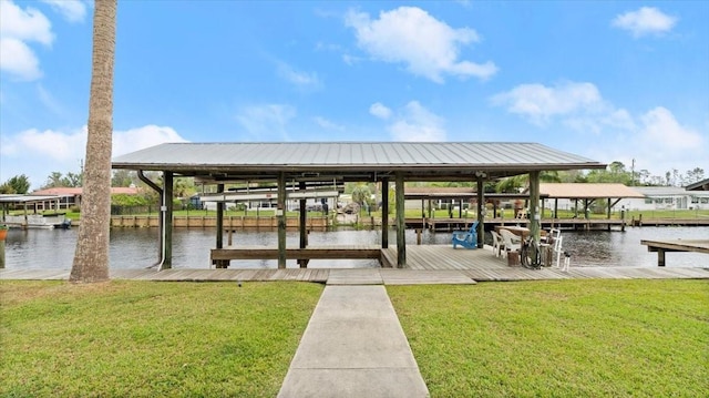 view of dock featuring a lawn, a water view, and boat lift