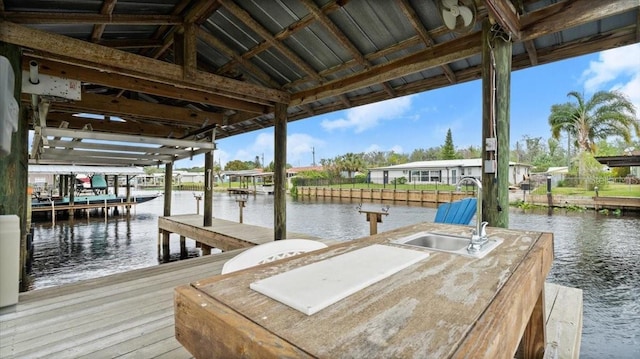 view of dock with a water view and a sink