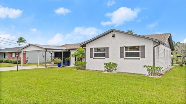 view of front facade featuring a front yard, an attached carport, and stucco siding