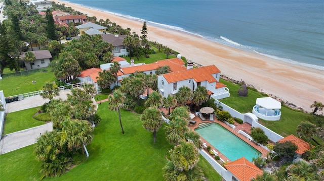 drone / aerial view with a water view and a view of the beach