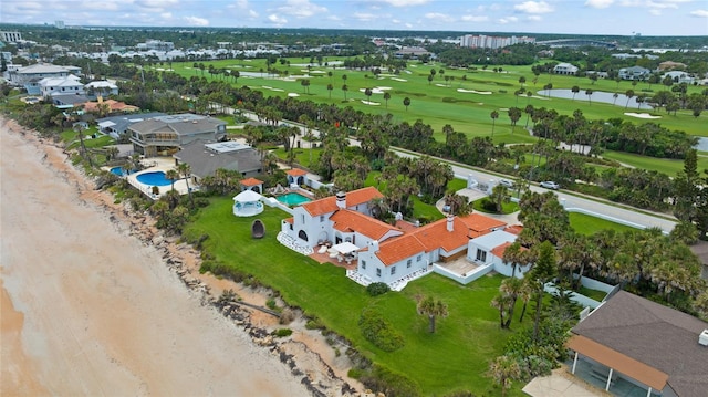 birds eye view of property featuring view of golf course and a water view