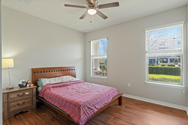 bedroom featuring multiple windows and wood finished floors