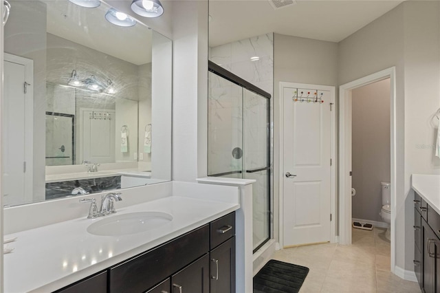 full bath featuring tile patterned floors, a shower stall, toilet, and vanity