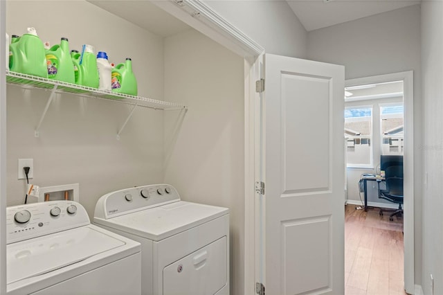 laundry room featuring laundry area, washing machine and dryer, and light wood-style floors