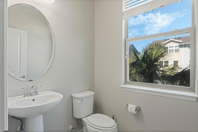 bathroom with toilet and a sink