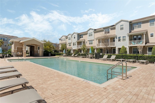 pool featuring a patio area, a residential view, and fence