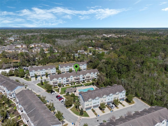 bird's eye view featuring a forest view and a residential view