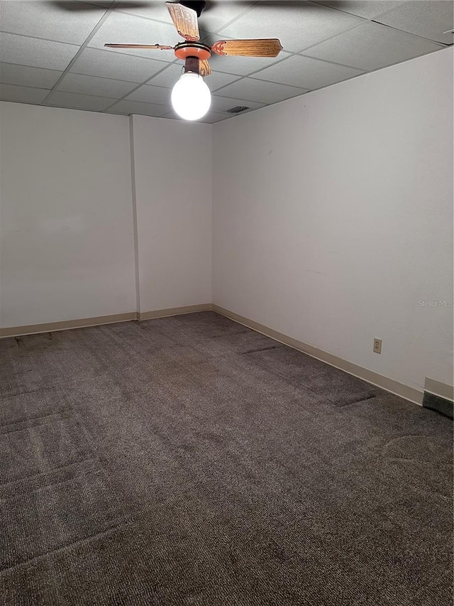 spare room featuring a ceiling fan, carpet, a paneled ceiling, and baseboards