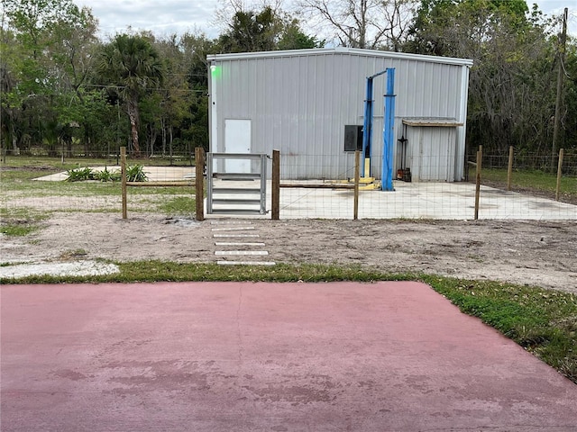 view of outbuilding with an outdoor structure and fence