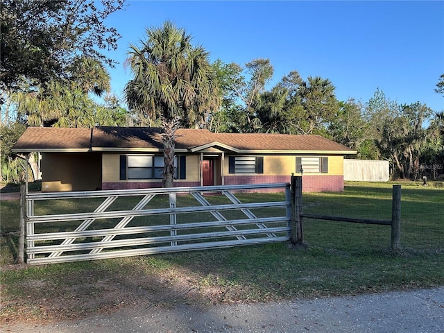 view of front of home with a fenced front yard and a front lawn