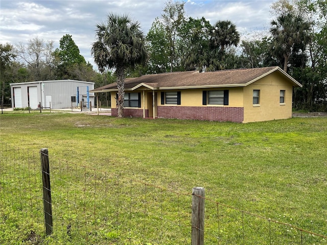 single story home with a front lawn, fence, and brick siding