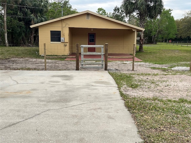 view of front of house featuring concrete block siding and a front yard