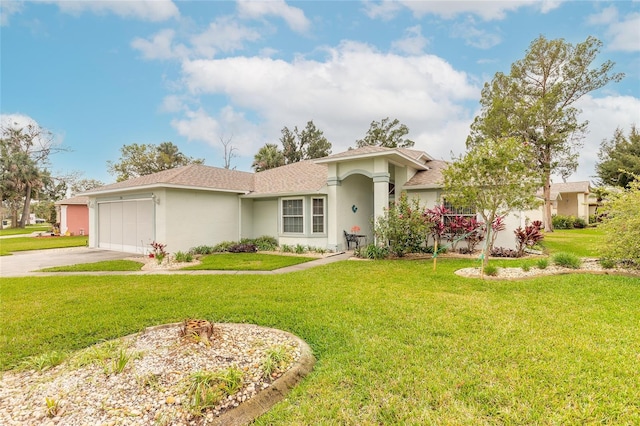 ranch-style house featuring a front yard, an attached garage, driveway, and stucco siding