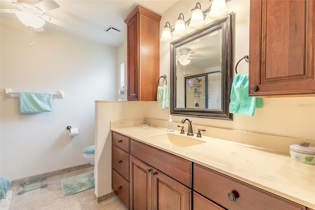 bathroom featuring visible vents, ceiling fan, toilet, a stall shower, and vanity