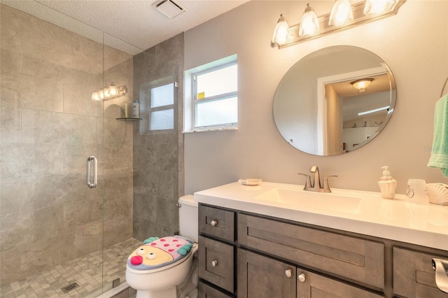 full bath featuring vanity, a shower stall, toilet, and visible vents