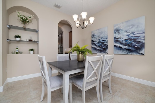 dining area featuring visible vents, a notable chandelier, baseboards, and light tile patterned floors