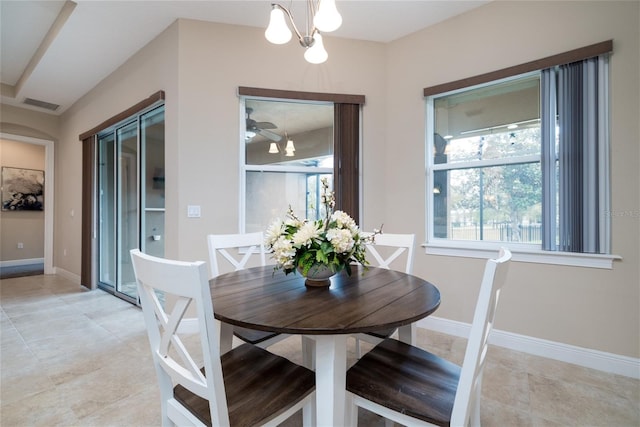 dining area featuring a chandelier, visible vents, and baseboards