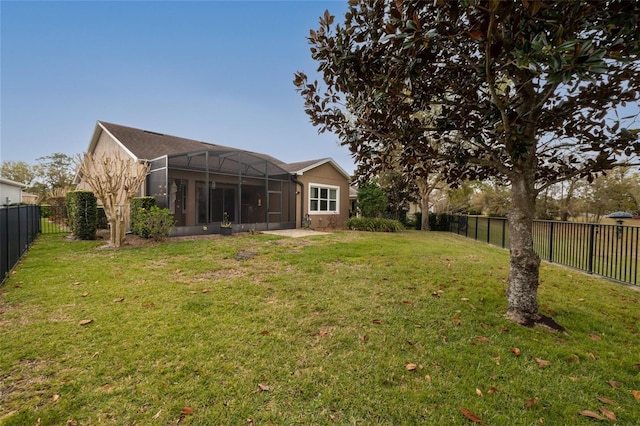 view of yard featuring glass enclosure and a fenced backyard