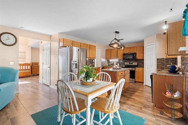 dining room featuring light wood finished floors and baseboards