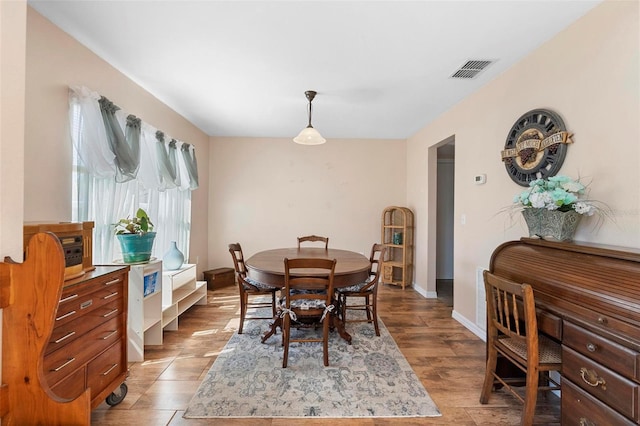 dining room with visible vents, baseboards, and light wood-style flooring