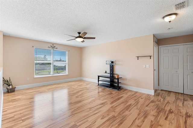 unfurnished living room featuring light wood finished floors, baseboards, and visible vents