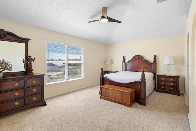 bedroom with lofted ceiling, a ceiling fan, light carpet, a textured ceiling, and baseboards