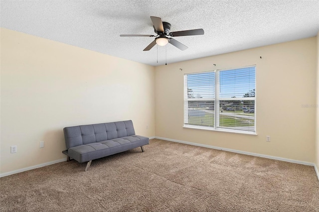 unfurnished room with a textured ceiling, carpet floors, and baseboards