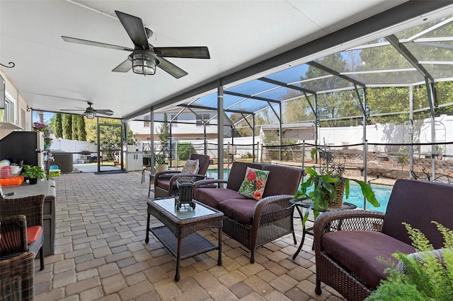 view of patio / terrace featuring a ceiling fan, glass enclosure, a fenced backyard, and outdoor lounge area