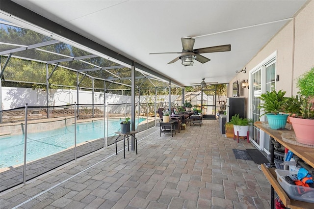 unfurnished sunroom featuring a ceiling fan