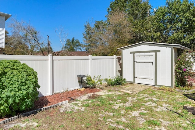 view of yard featuring an outdoor structure, a storage shed, and fence