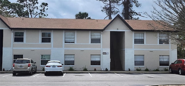 view of building exterior featuring uncovered parking