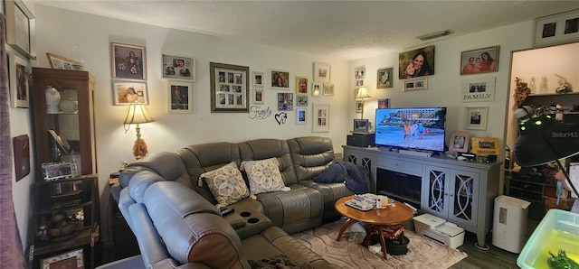 living area featuring visible vents and dark wood-style flooring