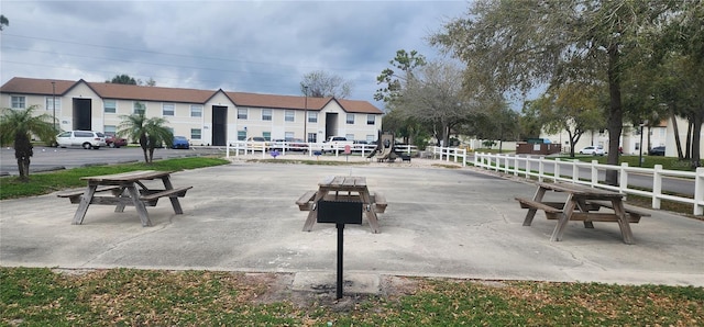 view of home's community featuring fence