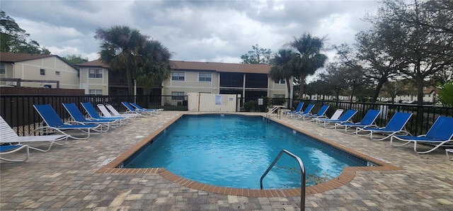 pool featuring a patio area and fence