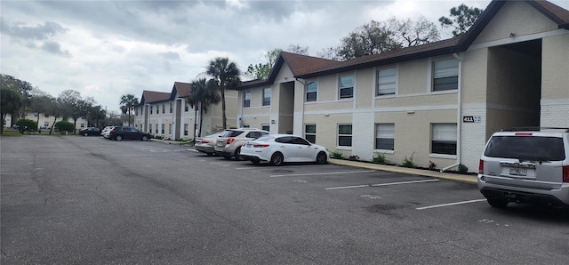 uncovered parking lot featuring a residential view