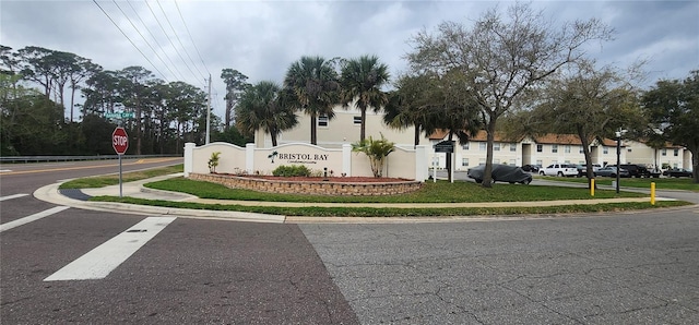 view of road with sidewalks, traffic signs, and curbs