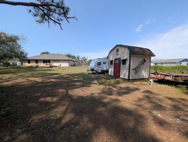 view of yard with a storage shed and an outbuilding