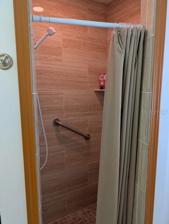 bathroom with tiled shower