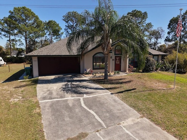 view of front of house with driveway, a garage, roof with shingles, a front lawn, and stucco siding