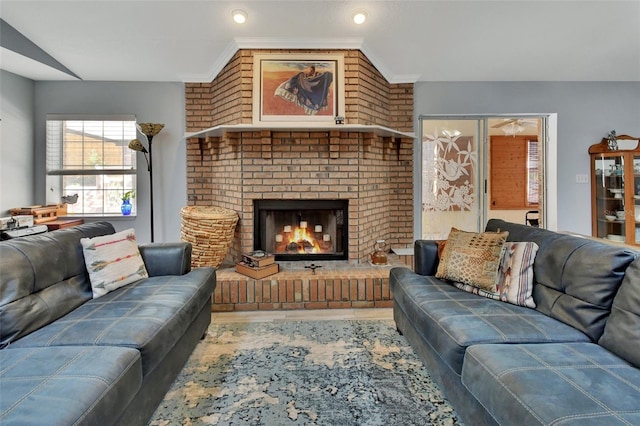 living room with crown molding and a fireplace