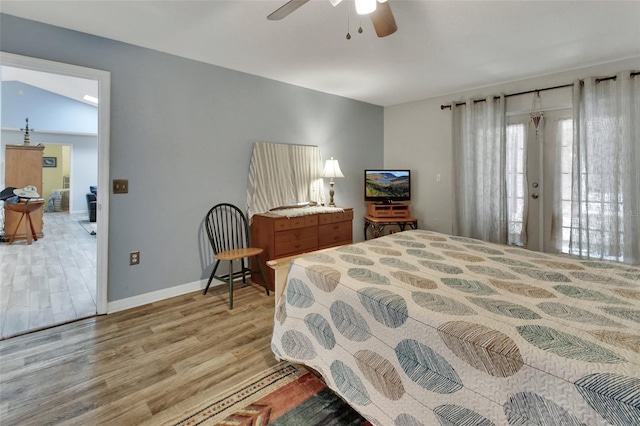 bedroom with ceiling fan, wood finished floors, and baseboards