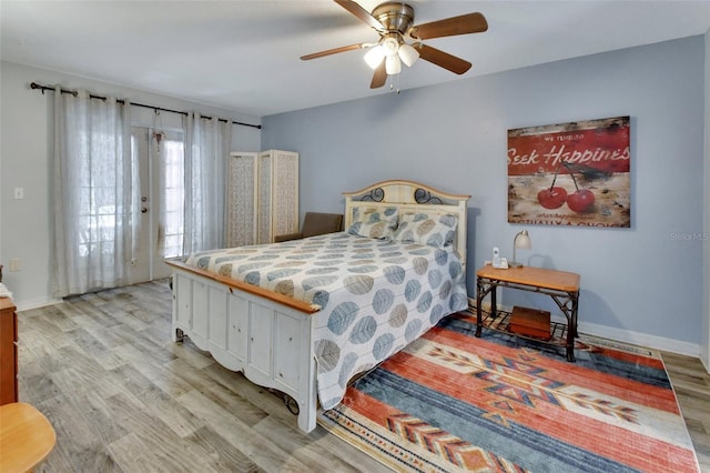 bedroom featuring baseboards, access to outside, and light wood-style floors