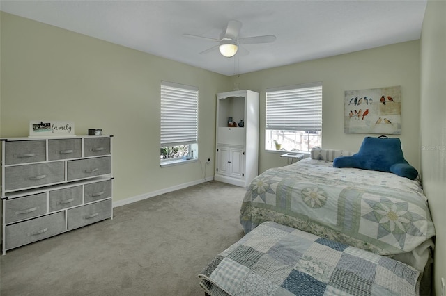 bedroom with carpet floors, multiple windows, baseboards, and a ceiling fan