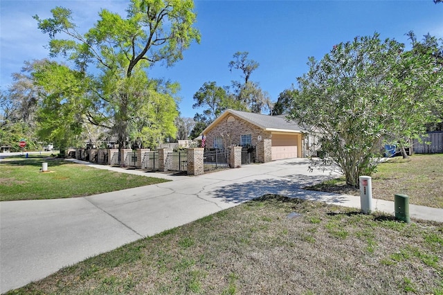 view of front of home featuring a fenced front yard, a front yard, concrete driveway, and brick siding