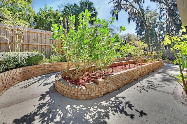 view of community with fence and a patio