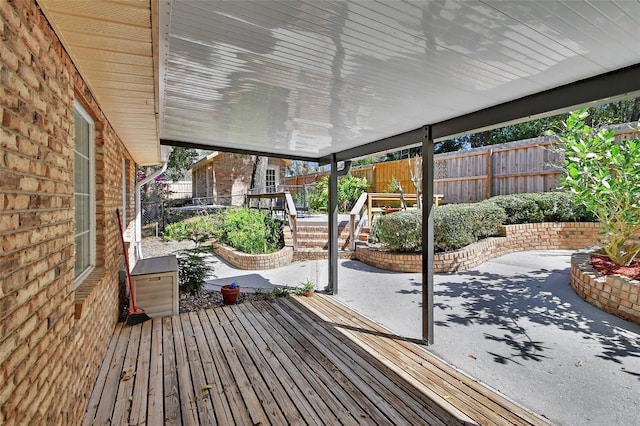 wooden terrace with a patio and fence