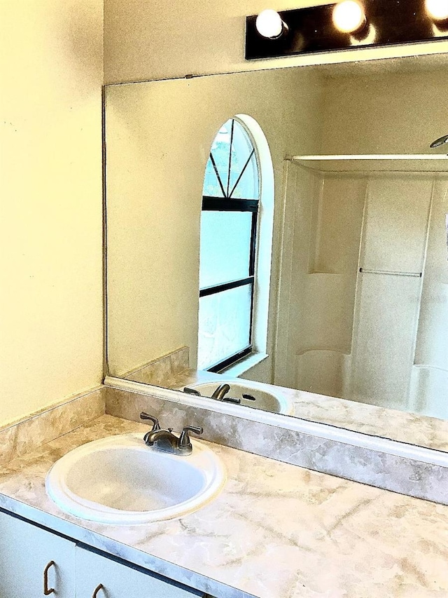 bathroom featuring a wealth of natural light and vanity