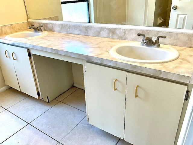 bathroom featuring tile patterned flooring, double vanity, and a sink