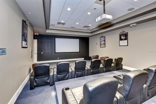 cinema room with carpet, visible vents, baseboards, a tray ceiling, and recessed lighting